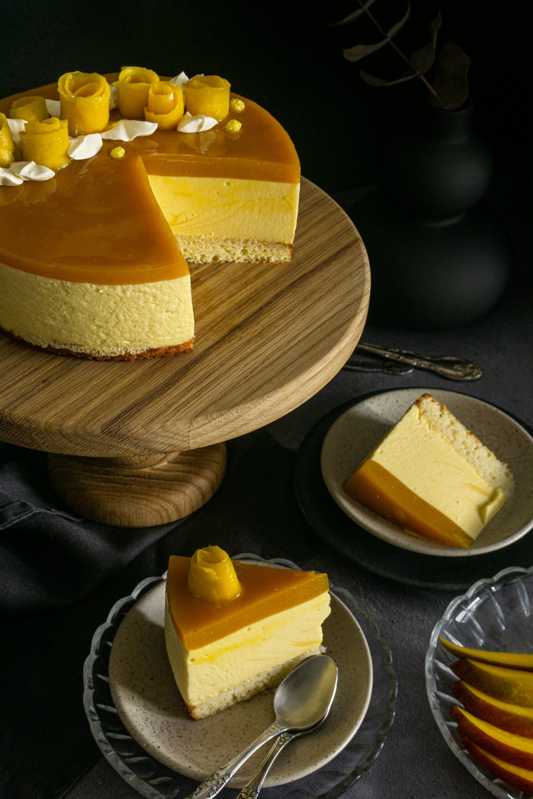 Two pieces of mango mousse cake in plates