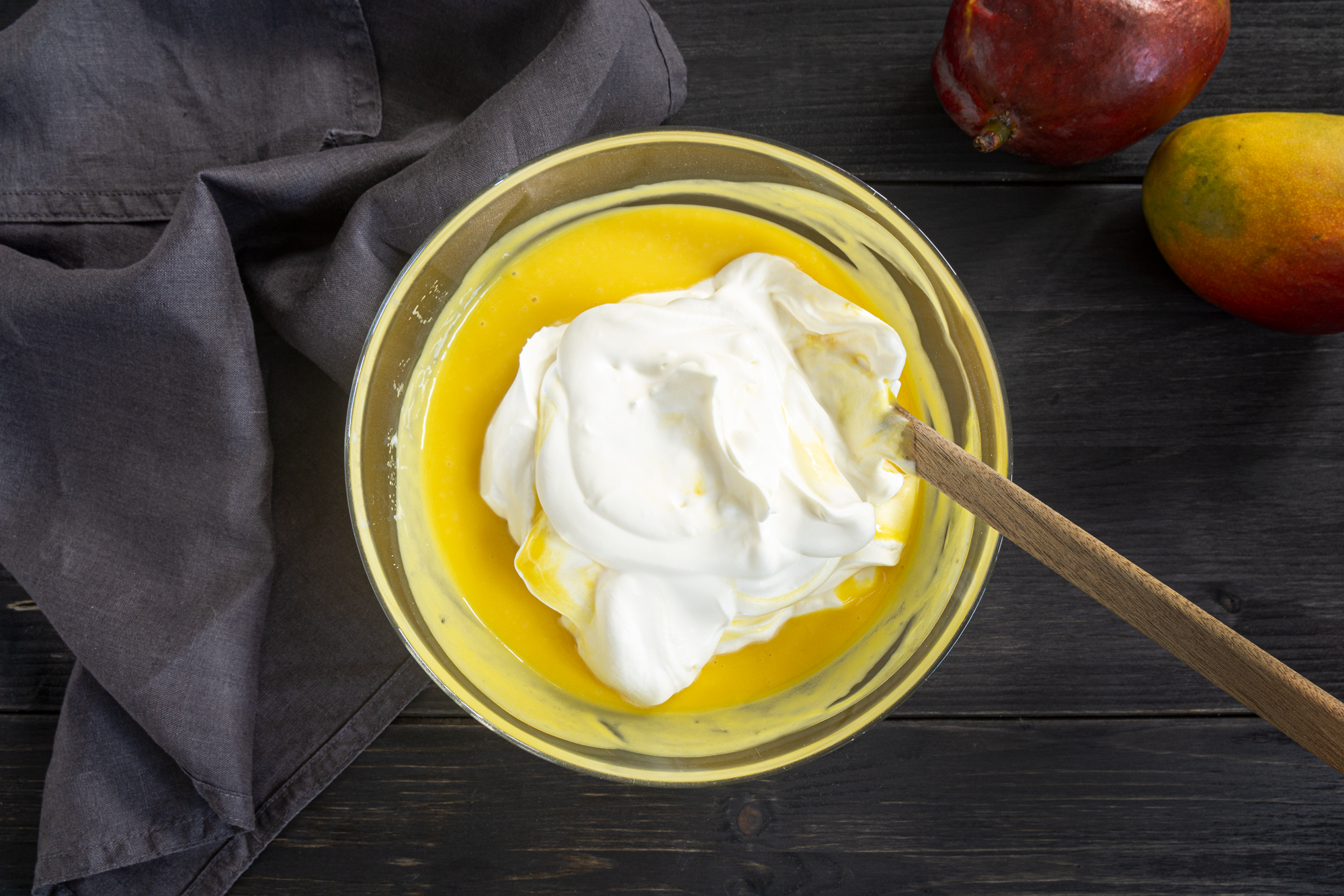 Mixing whipped cream with mango puree