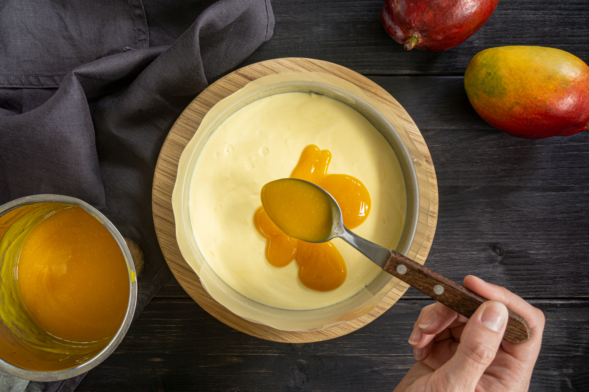 Pouring mango puree on top of the mousse