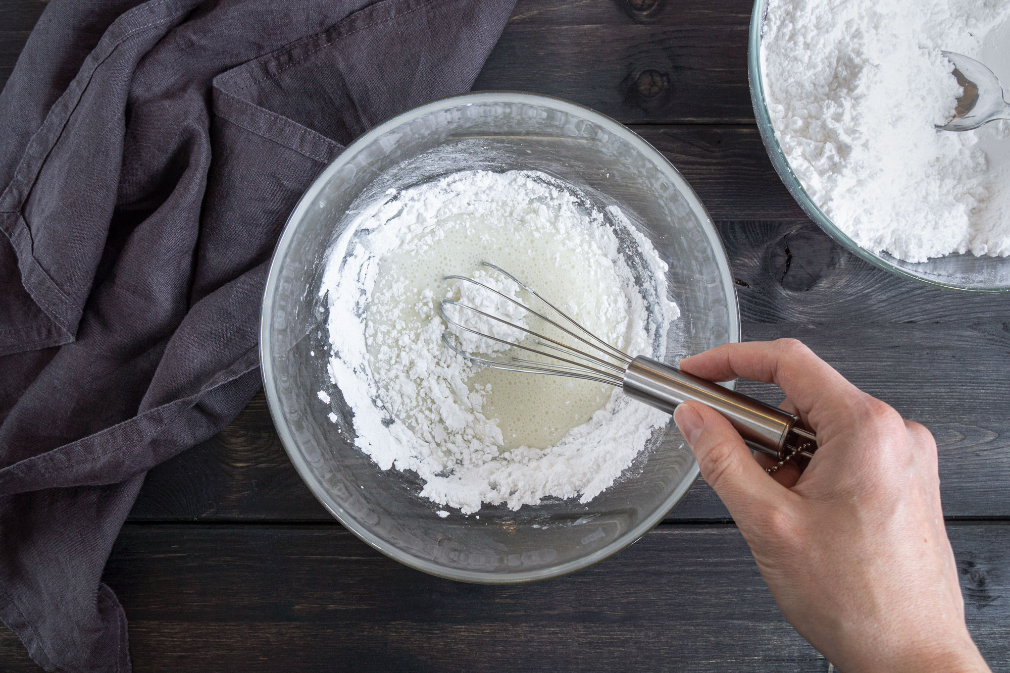 Mixing icing sugar with milk
