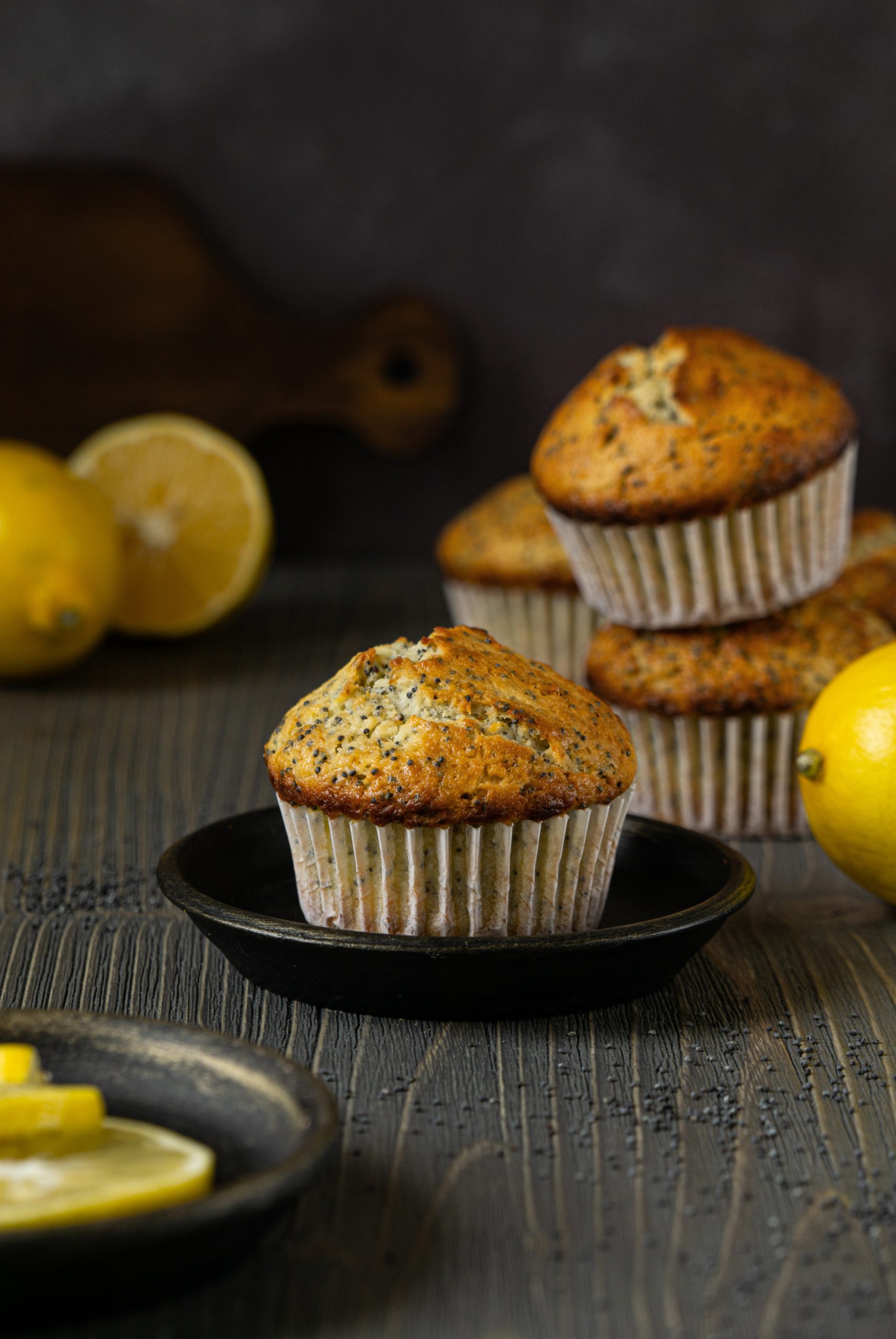 Close up of lemon poppy seed muffin on a dark background