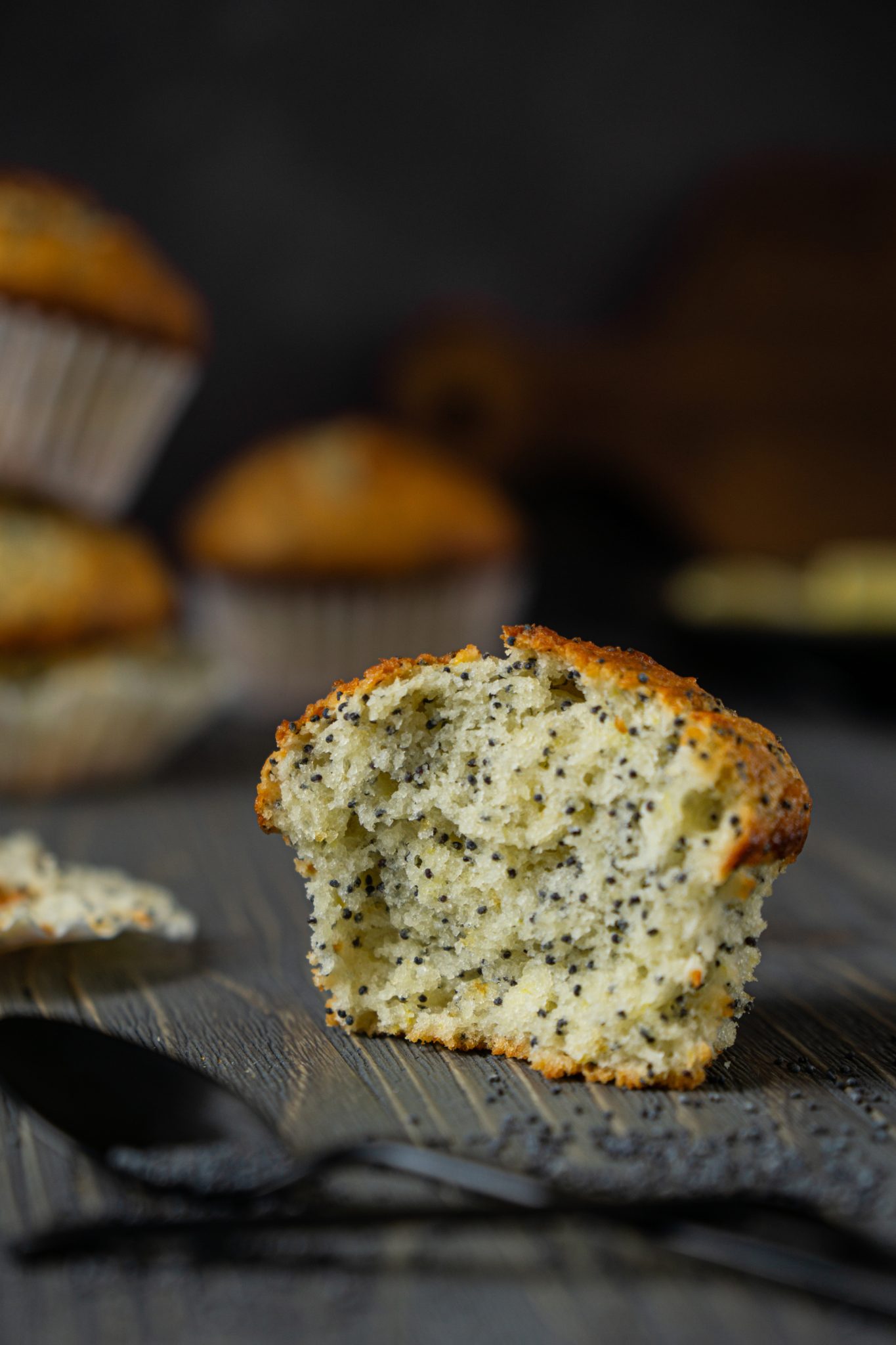 Close up of lemon poppy seed muffins on a dark background