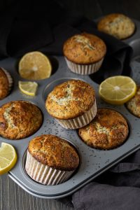 Lemon poppy seed muffins on a dark background