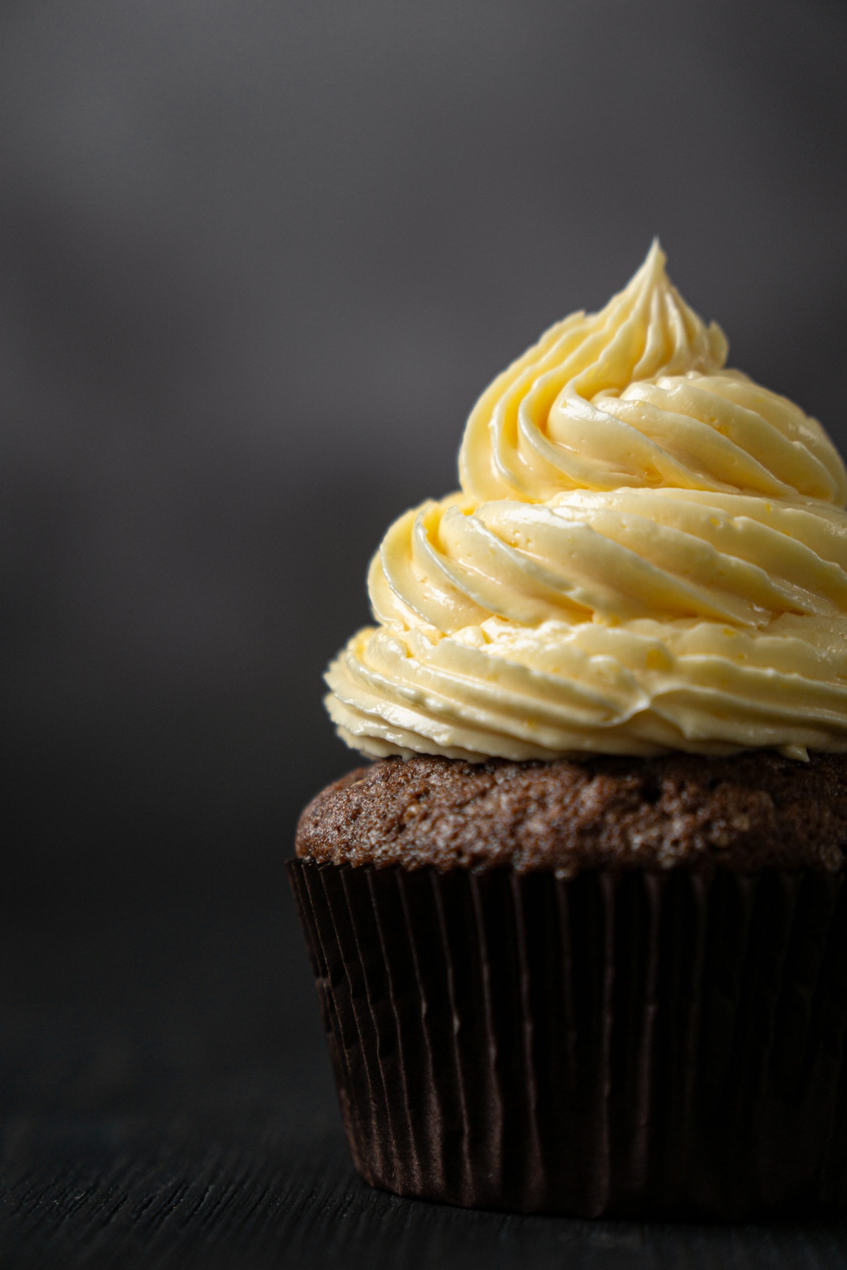 Close up of a chocolate cupcake frosted with French buttercream