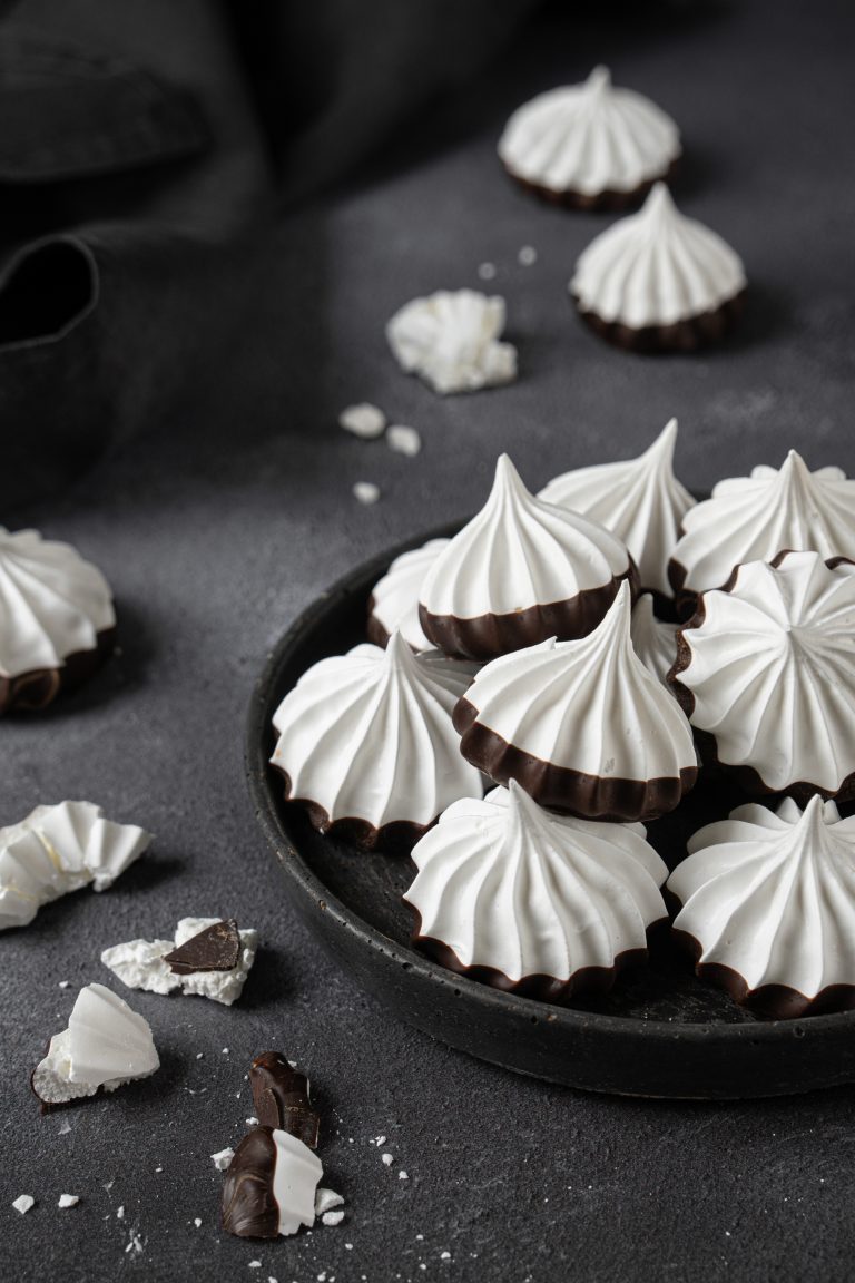 Chocolate dipped Swiss meringue kisses served in a plate