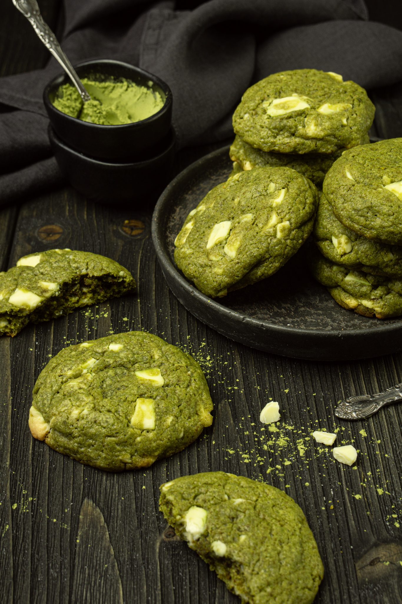 Matcha white chocolate chip cookies on a dark background