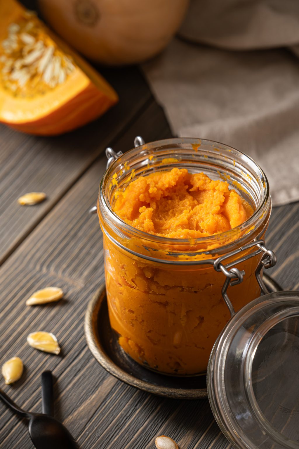 Close-up of a glass jar filled with homemade pumpkin puree