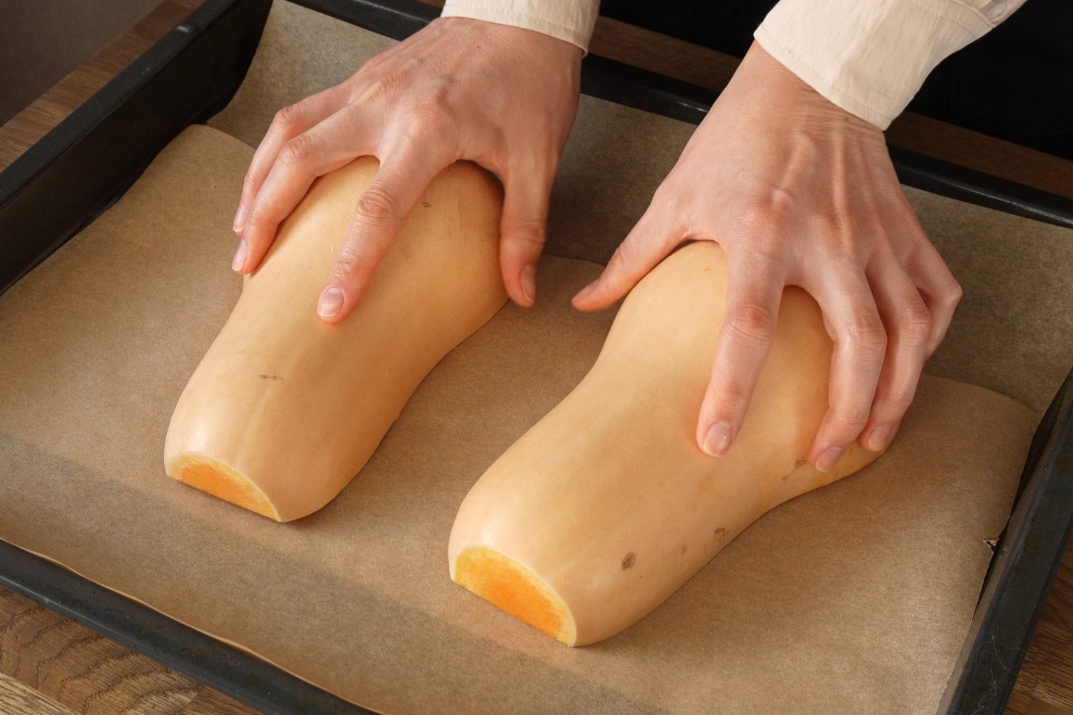 Butternut squash cut in half and placed on a baking sheet