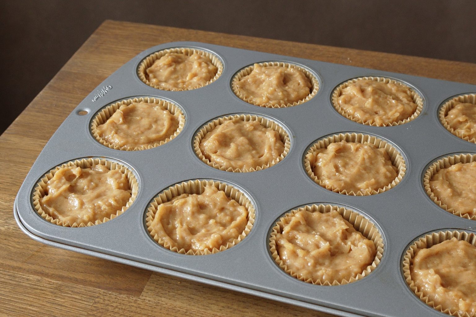 Baking pan filled with apple muffin batter