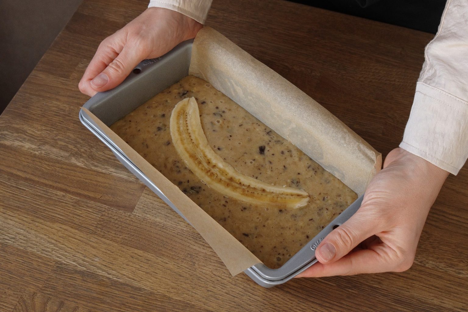 Chocolate chip banana bread batter in a loaf pan ready to bake