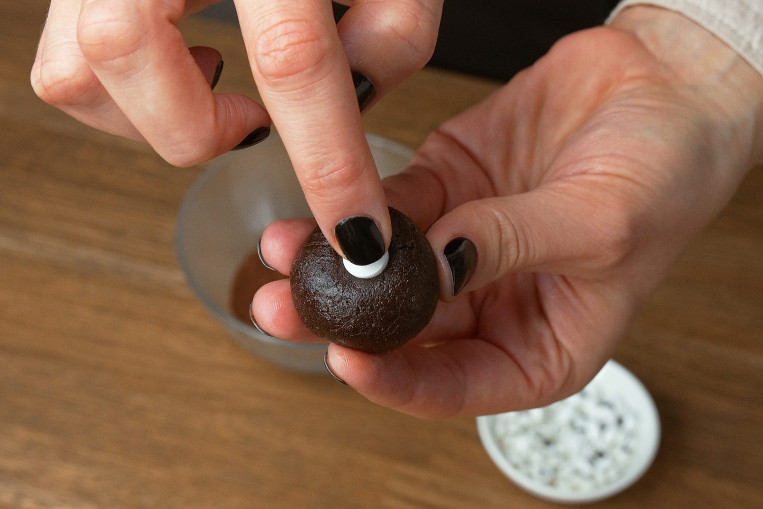 Pressing an eye sprinkle into a truffle