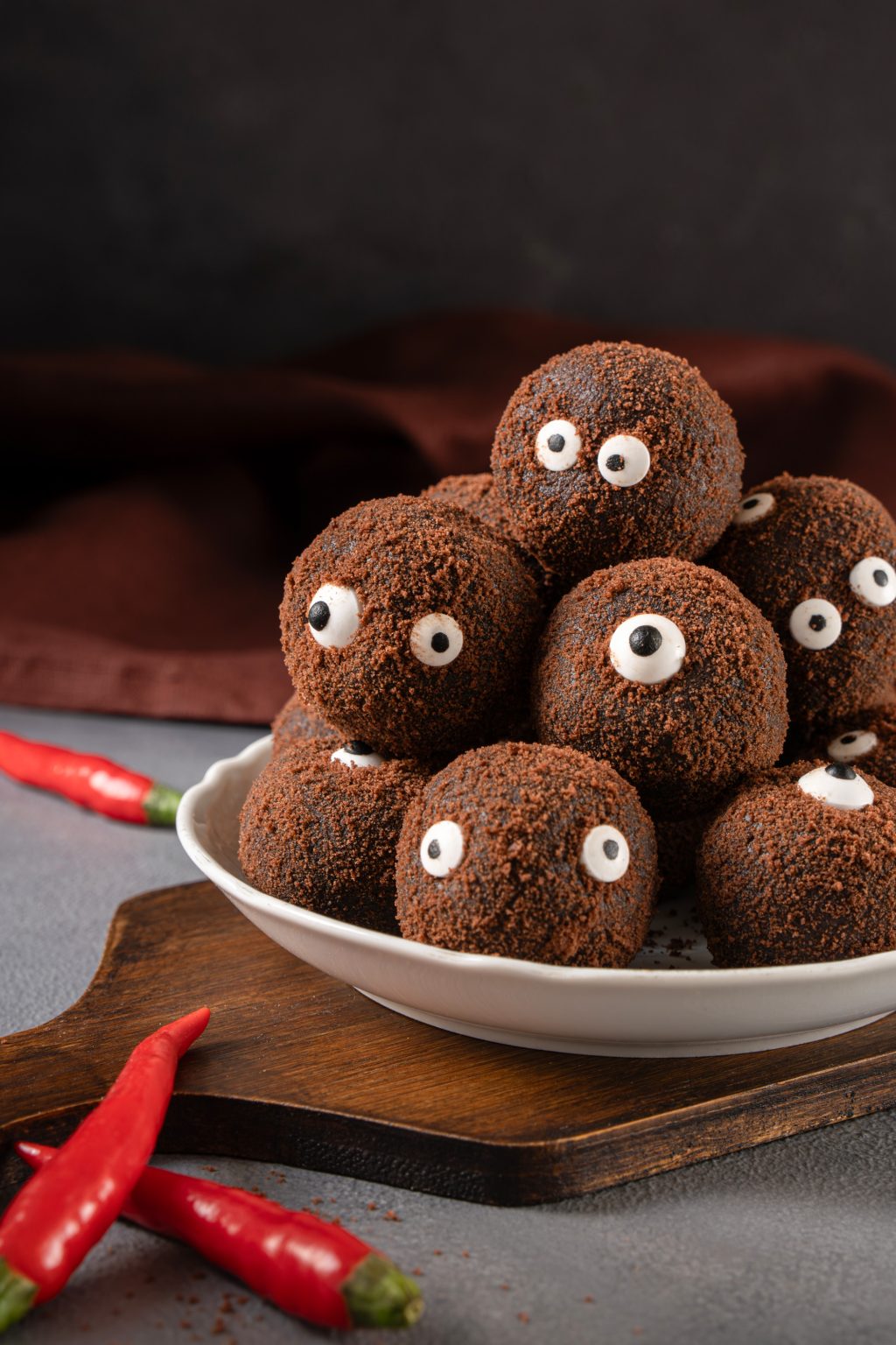 Halloween monster truffles stacked on a plate