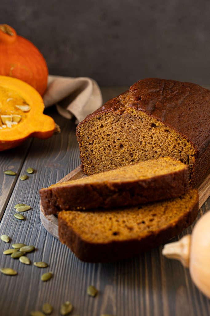 Sliced pumpkin bread served on a wooden tray