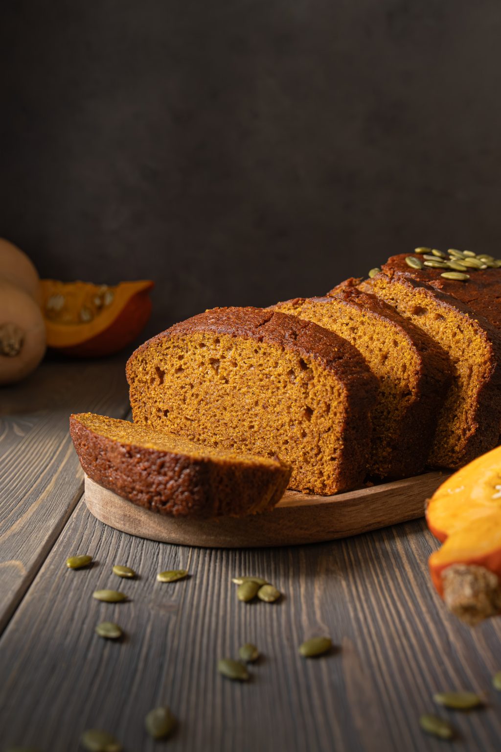 Sliced pumpkin bread served on a wooden tray