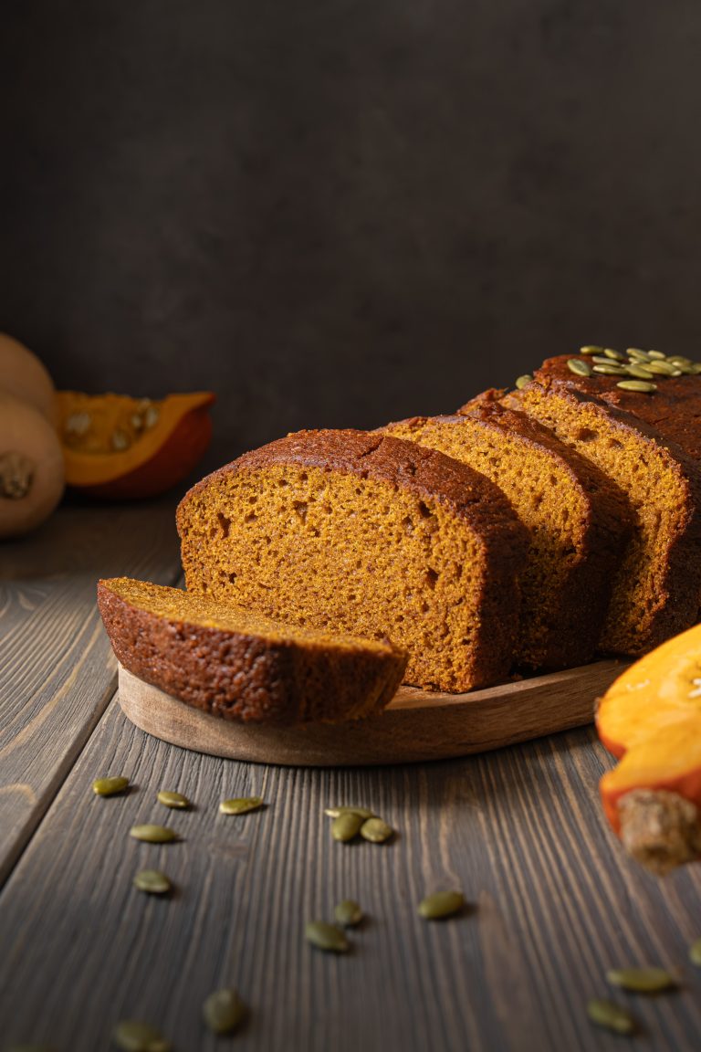 Sliced pumpkin bread served on a wooden tray