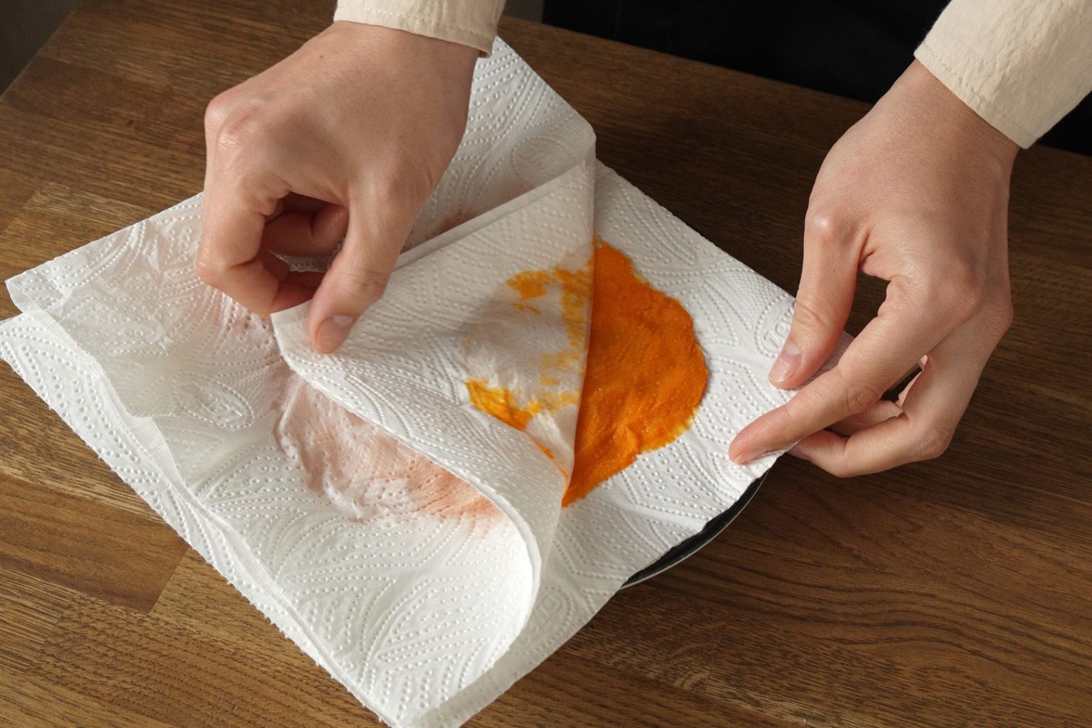 Peeling the paper towel of the blotted pumpkin puree