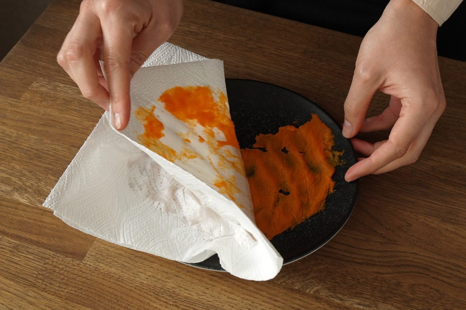 Peeling the paper towel of the blotted pumpkin puree