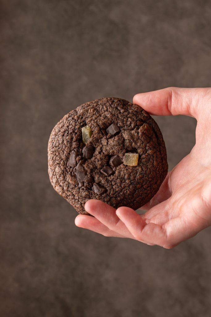 Chocolate ginger cookie held in a hand