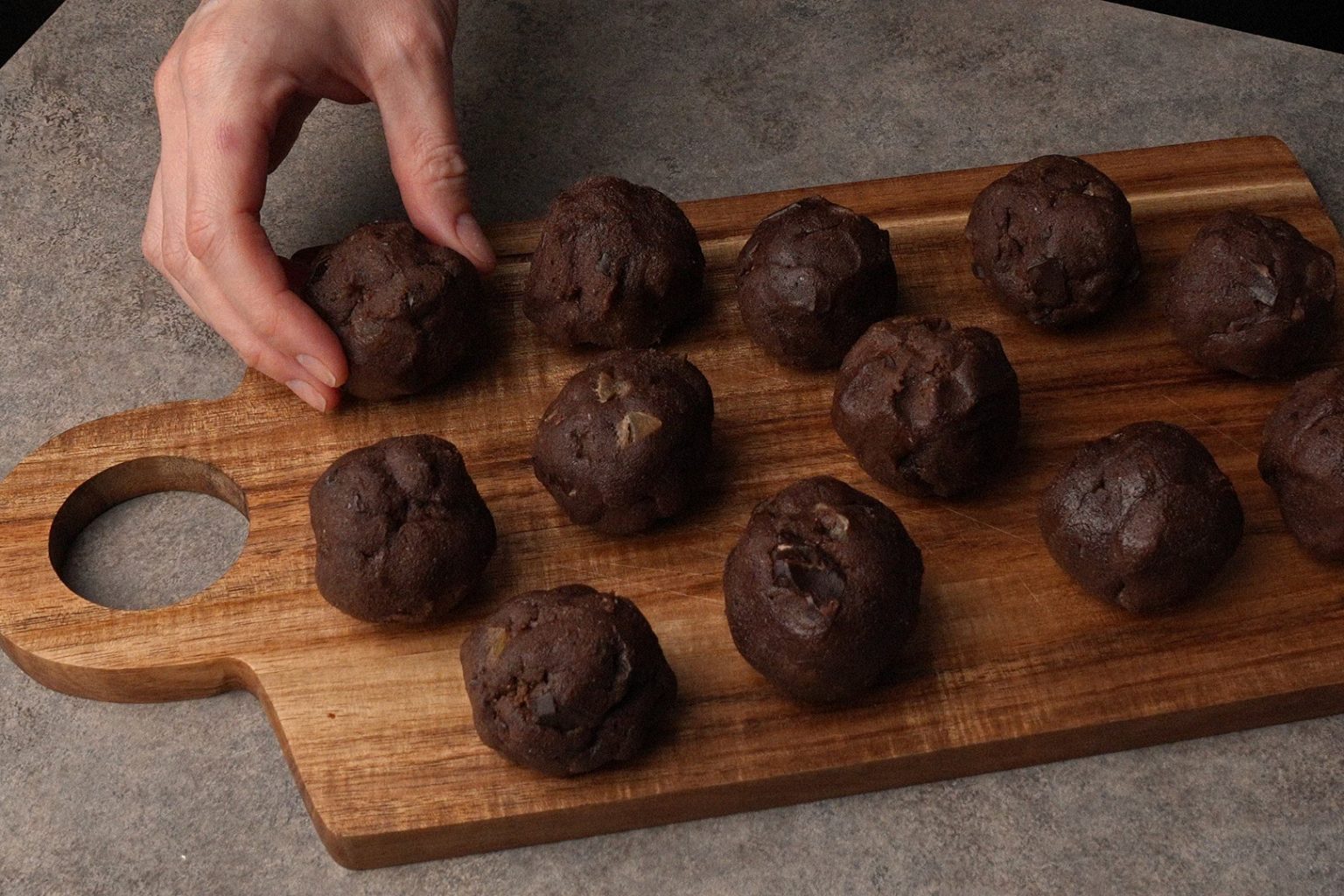 Chocolate ginger cookie dough balls on a cutting board