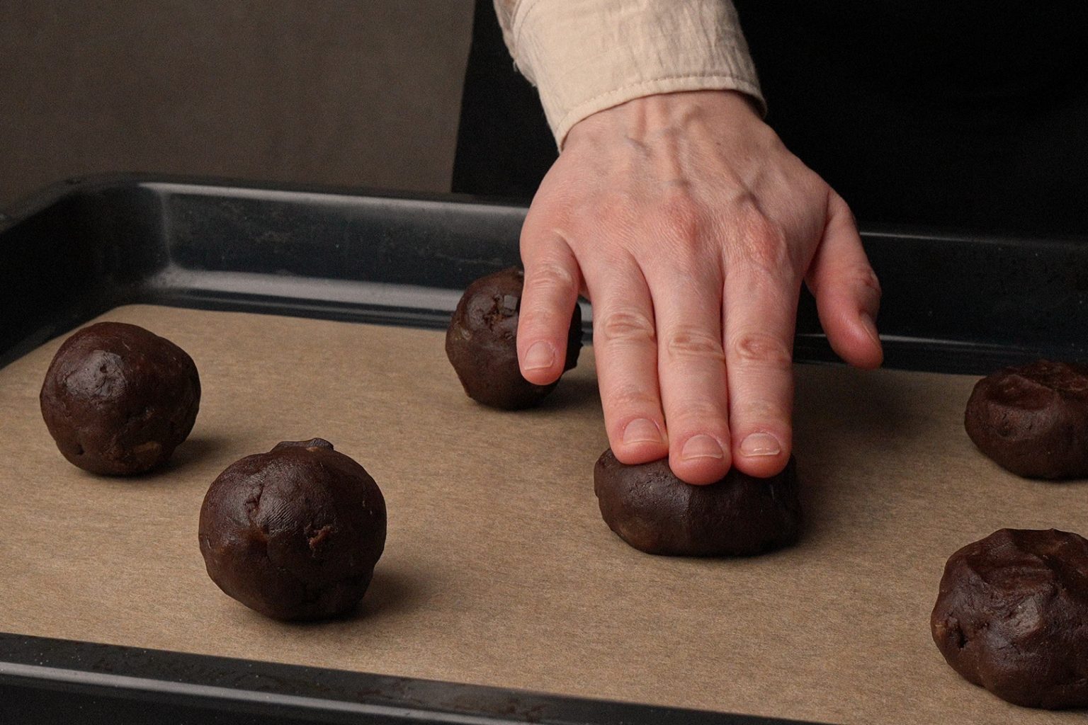 Flattening chocolate ginger cookie dough balls