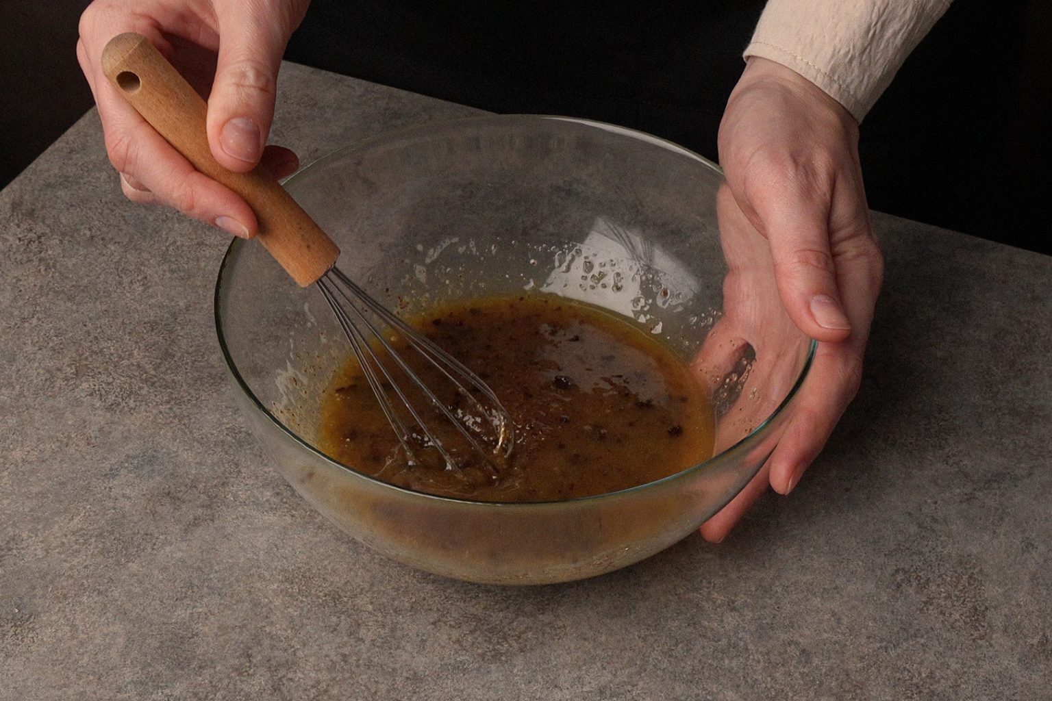 Melted butter mixed with light brown and dark brown sugars is a bowl