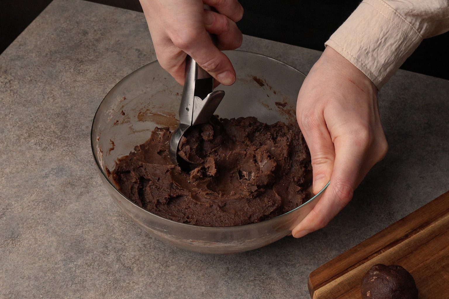 Scooping chilled chocolate ginger cookie dough